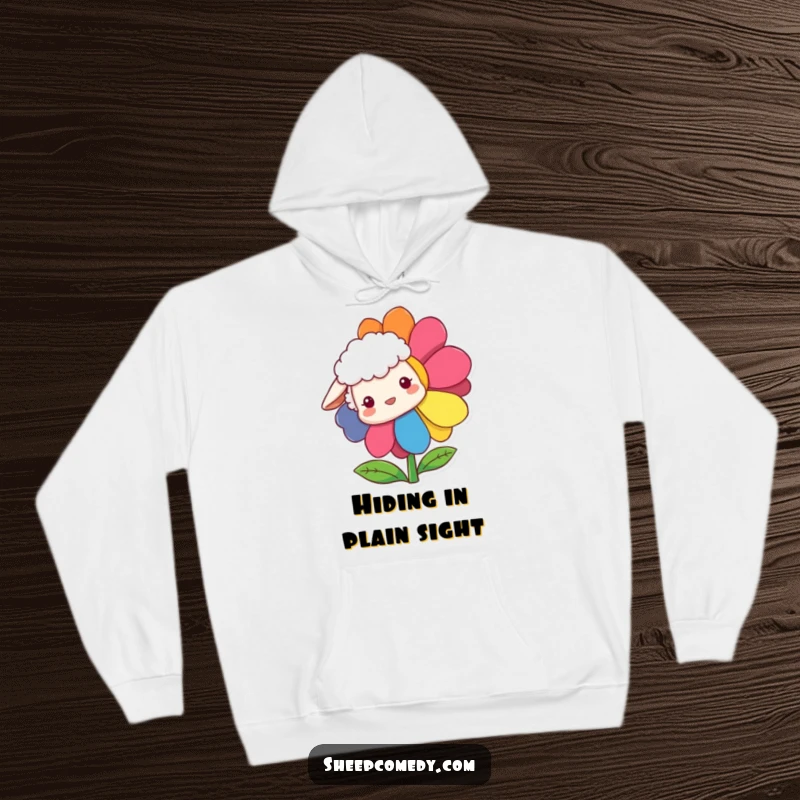Funny Sheep Hoodie with a sheep curiously peeking from behind a large, vibrant rainbow flower, cozy and full of fun.