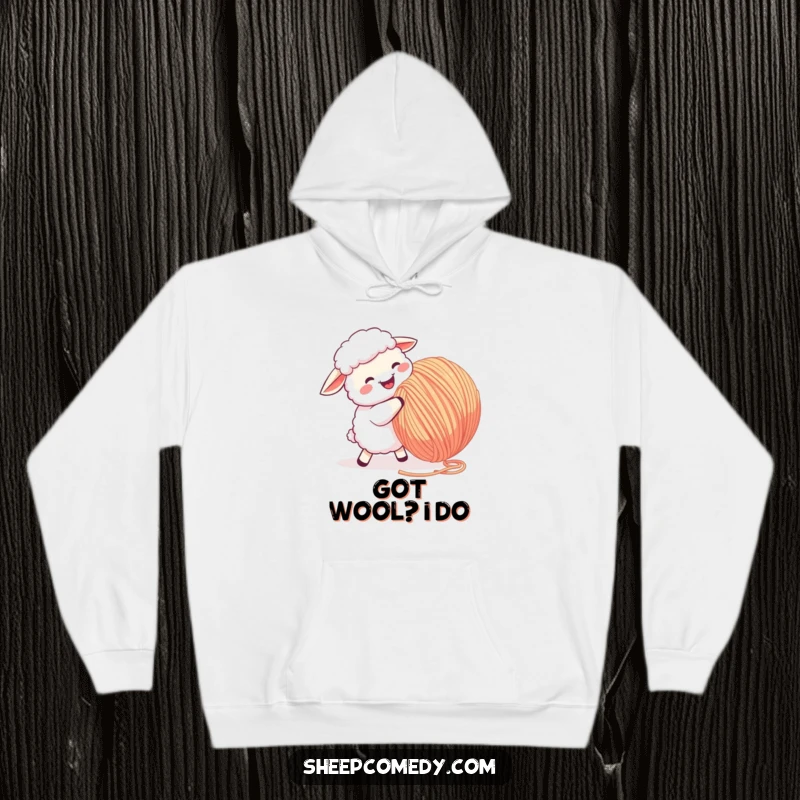 Funny Sheep Hoodie: A happy sheep energetically butts a giant ball of yarn, perfect for cozy, funny vibes.