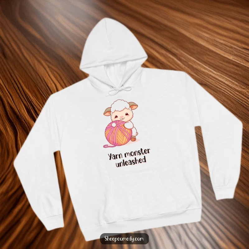 Funny Sheep Hoodie: A sheep character happily playing with a large, colorful ball of yarn, offering cozy and humorous vibes.